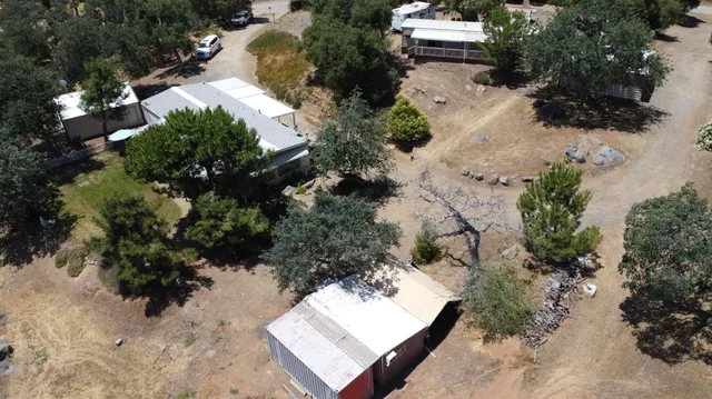 an aerial view of a house with a yard and lake view