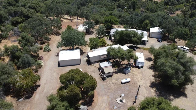 an aerial view of a house with a yard
