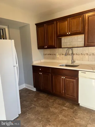 a kitchen with a sink and a refrigerator