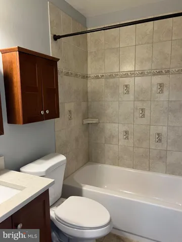 a bathroom with a toilet a sink and bathtub