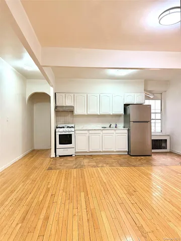 a view of a kitchen with a sink and a stove top oven