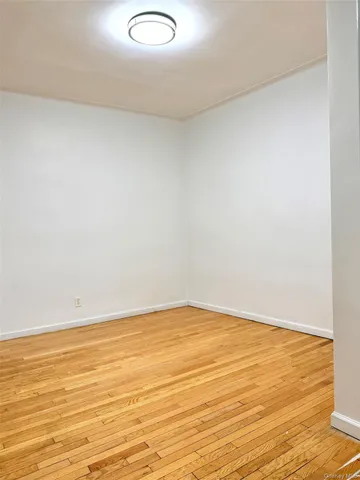 a view of an empty room and wooden floor