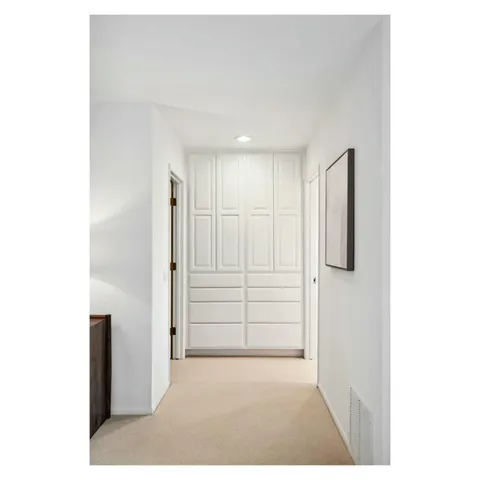a view of a patio with table and chairs under an umbrella