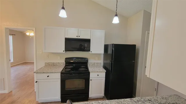 a view of a kitchen with a sink and a chandelier