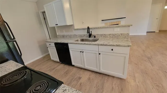 a kitchen with a refrigerator and a stove top oven