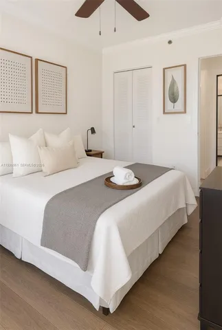 a bedroom with a bed and a night stand