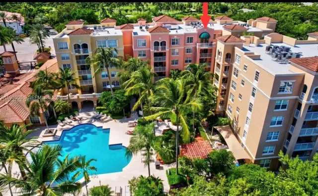 a aerial view of multi story residential apartment building with yard