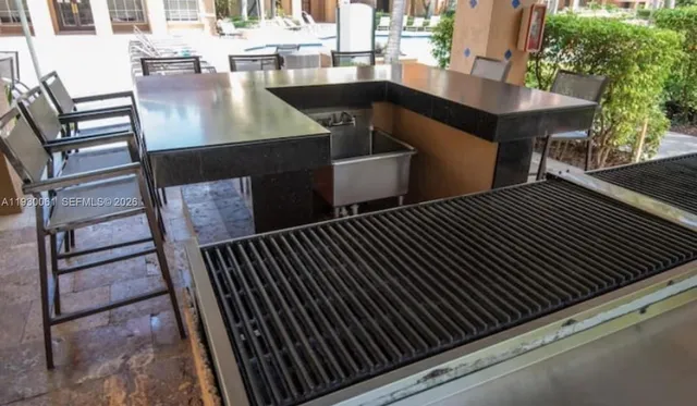 a view of a backyard with brick wall and potted plants