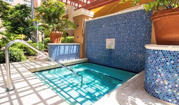 a view of a swimming pool with lounge chairs in patio