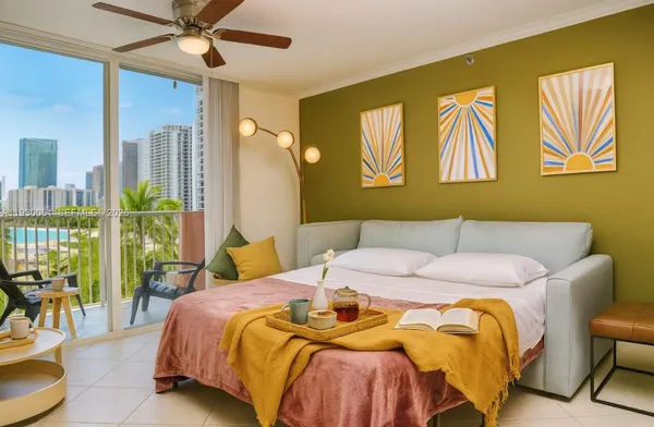 a bedroom with a bed and a painting on the wall