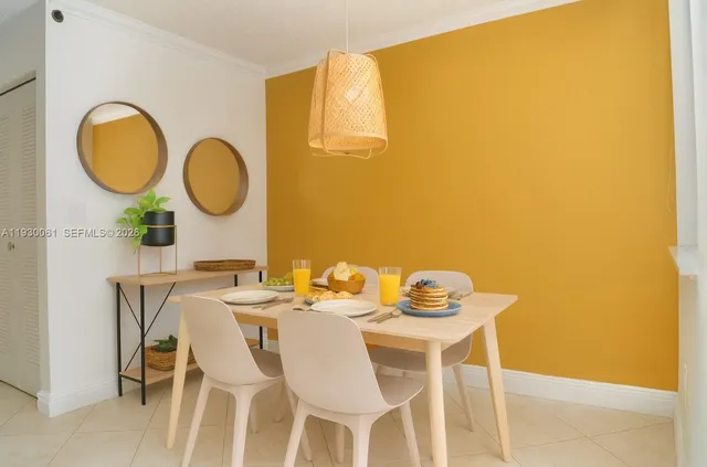 a dining room with furniture and a window