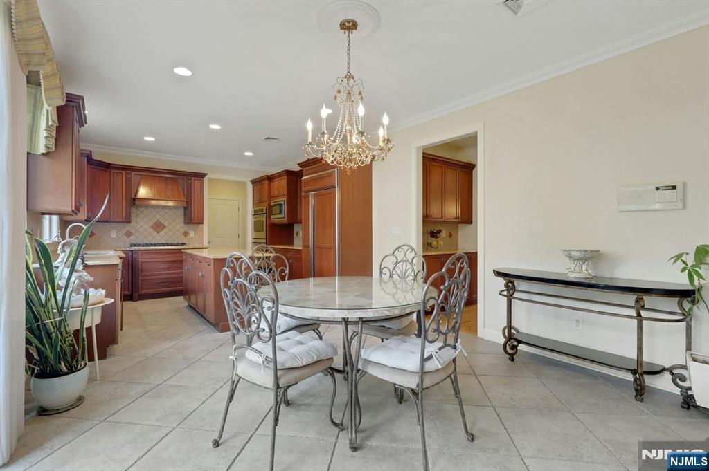 520 Homans Avenue Closter, NJ 07624 - Photo 11 of 34 a dining room with furniture and chandelier