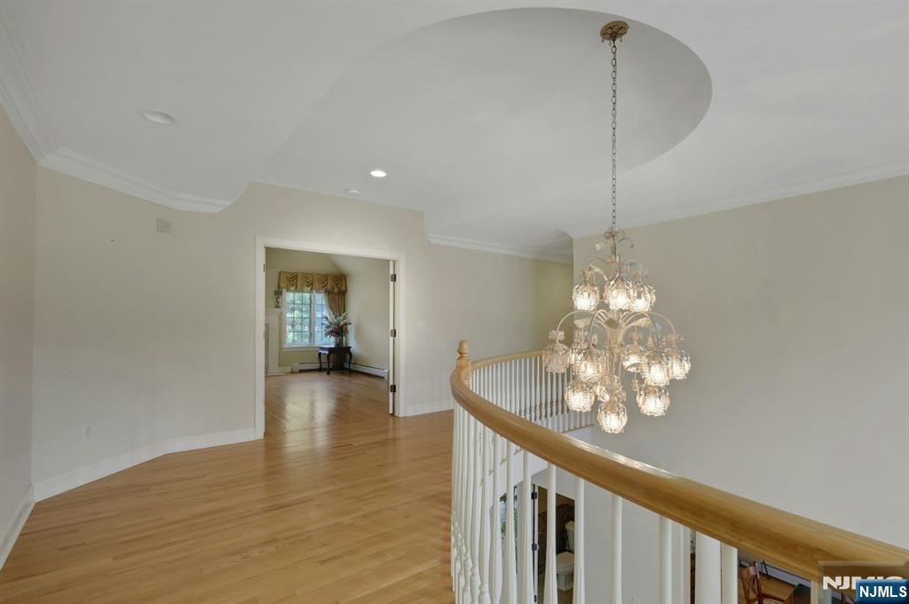 520 Homans Avenue Closter, NJ 07624 - Photo 16 of 34 a view of a chandelier and wooden floor in an empty room