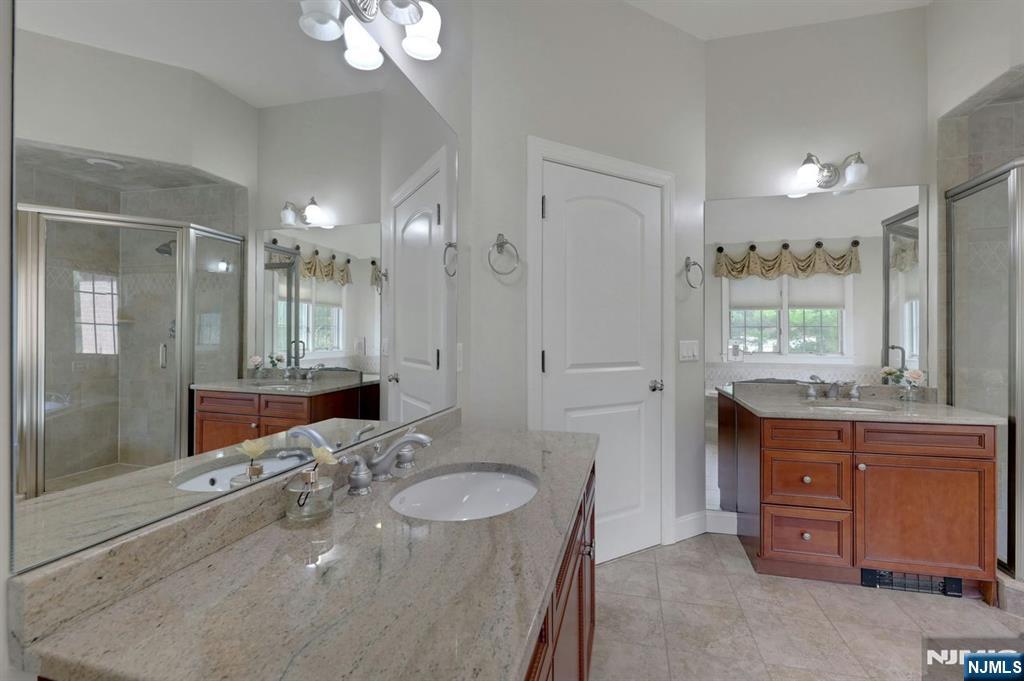 520 Homans Avenue Closter, NJ 07624 - Photo 19 of 34 a bathroom with a granite countertop sink a toilet a large mirror and shower