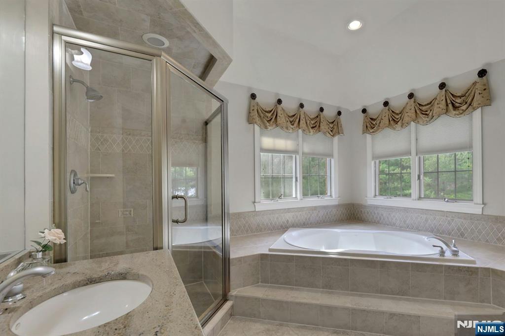 520 Homans Avenue Closter, NJ 07624 - Photo 20 of 34 a bathroom with a granite countertop tub shower and sink
