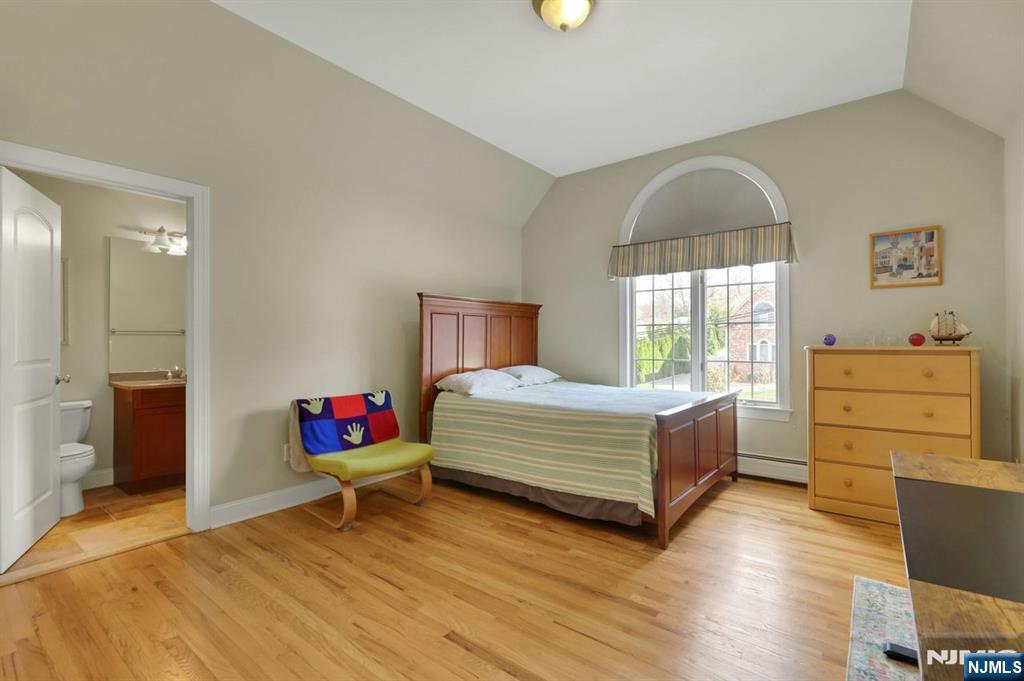 520 Homans Avenue Closter, NJ 07624 - Photo 23 of 34 a bedroom with a bed and wooden floor