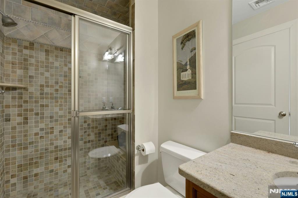 520 Homans Avenue Closter, NJ 07624 - Photo 24 of 34 a bathroom with a granite countertop sink a toilet and shower