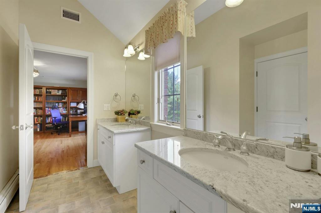520 Homans Avenue Closter, NJ 07624 - Photo 26 of 34 a en suite bathroom with a granite countertop sink and a mirror