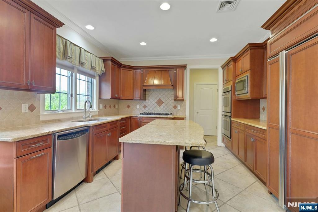 520 Homans Avenue Closter, NJ 07624 - Photo 9 of 34 a kitchen with stainless steel appliances granite countertop a refrigerator and a sink