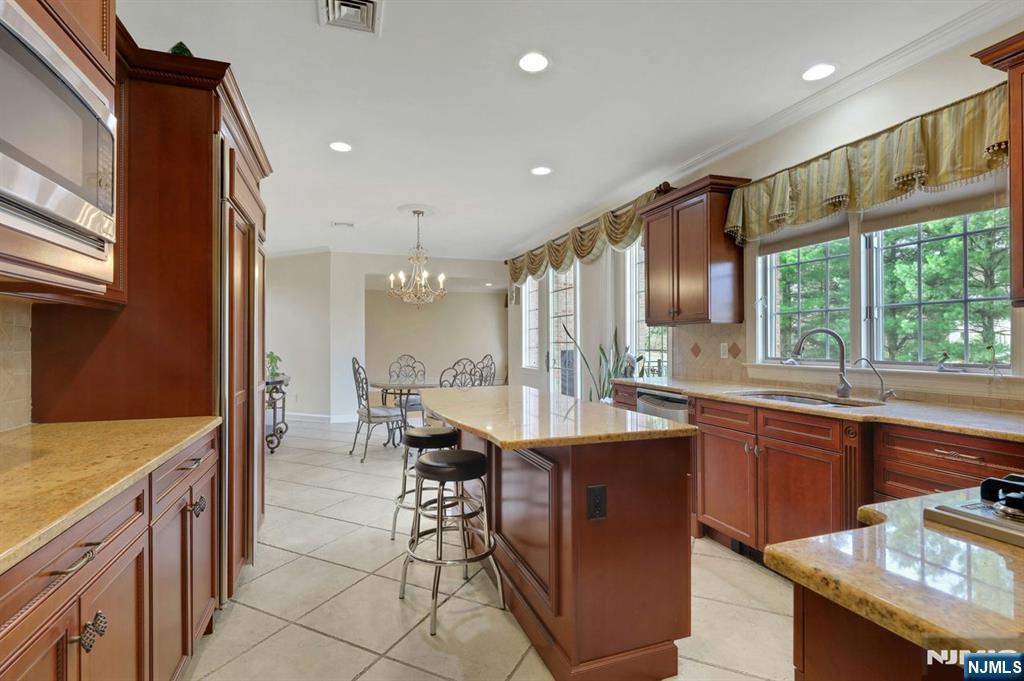 520 Homans Avenue Closter, NJ 07624 - Photo 10 of 34 a kitchen with kitchen island granite countertop a sink and stove