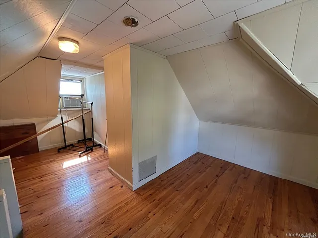a view of a room with wooden floor and chair