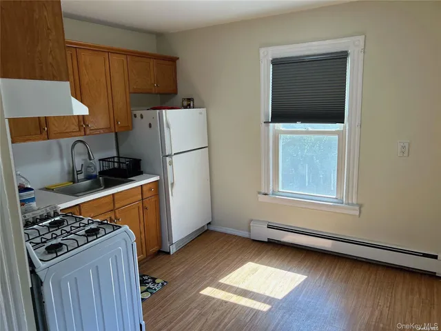 a kitchen with a stove a refrigerator and a sink
