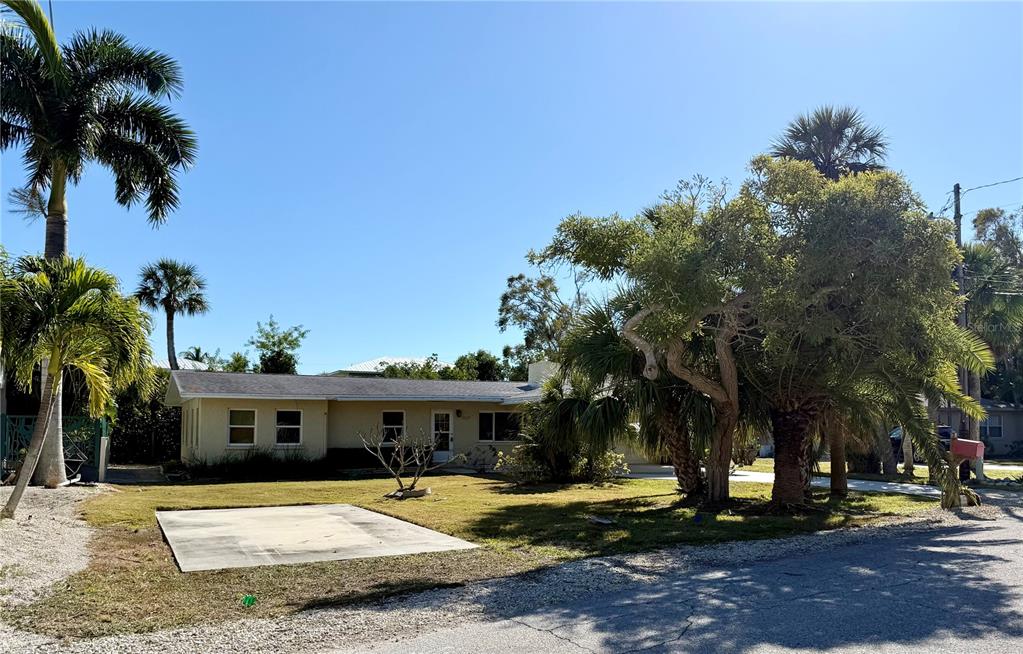 507 58th Street Holmes Beach, FL 34217 - Photo 17 of 19 a front view of a house with a yard and tree s