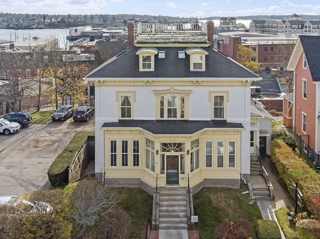 an aerial view of a house with a yard