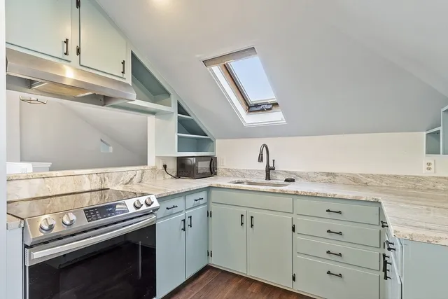 a kitchen with a stove oven and sink