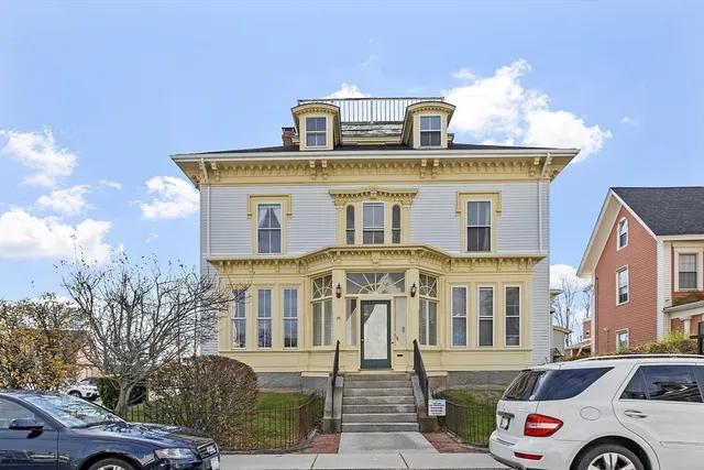 a front view of a residential apartment building with a yard