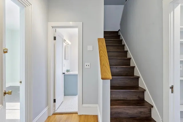 a view of a hallway with wooden floor and entryway