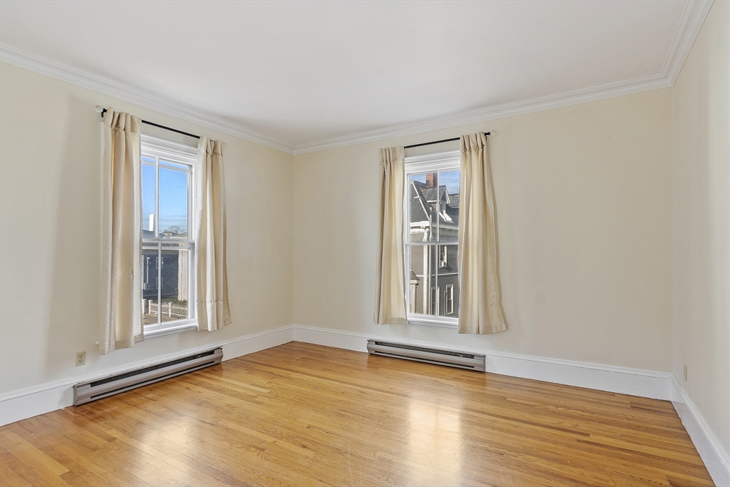 35 Middle Street, Unit 4 Gloucester, MA 01930 - Photo 6 of 28 a view of an empty room with wooden floor and a window