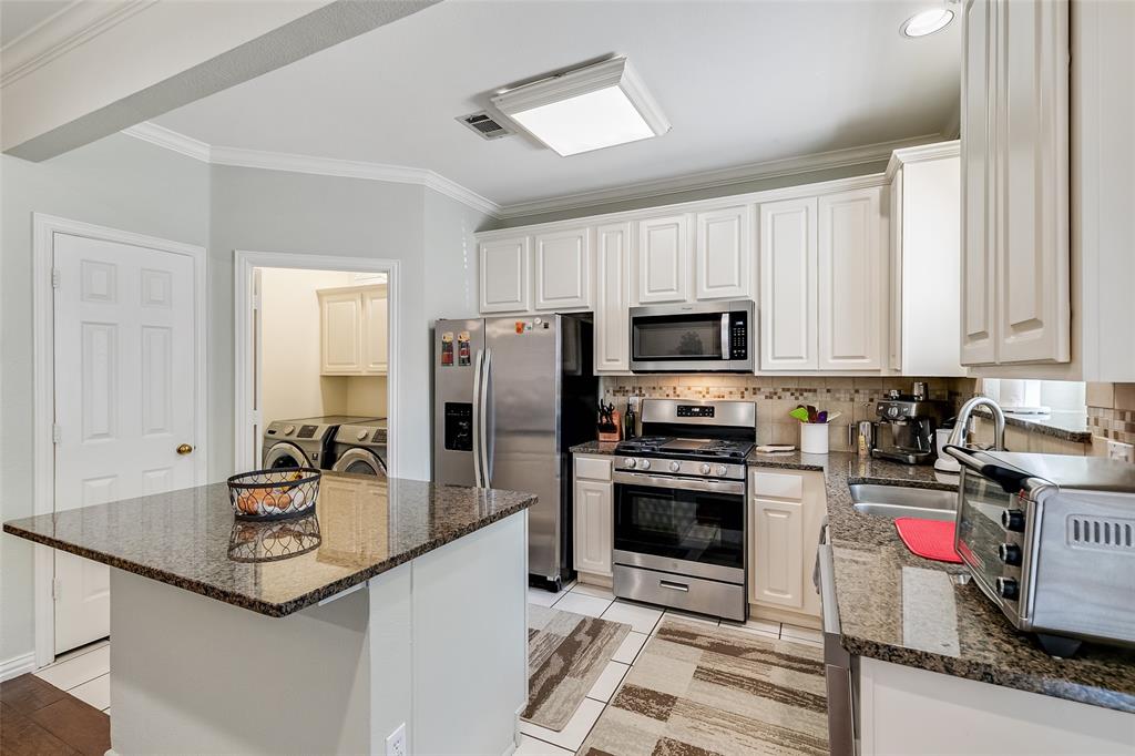 18240 Midway Road, Unit 1004 Dallas, TX 75287 - Photo 12 of 22 a kitchen with stainless steel appliances granite countertop a sink stove and refrigerator