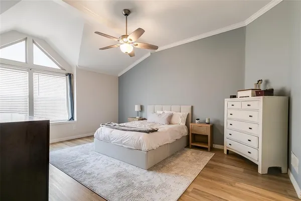 a bedroom with a large bed and a chandelier