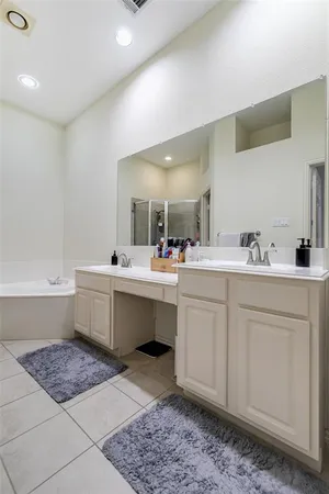 a bathroom with a sink mirror and a
