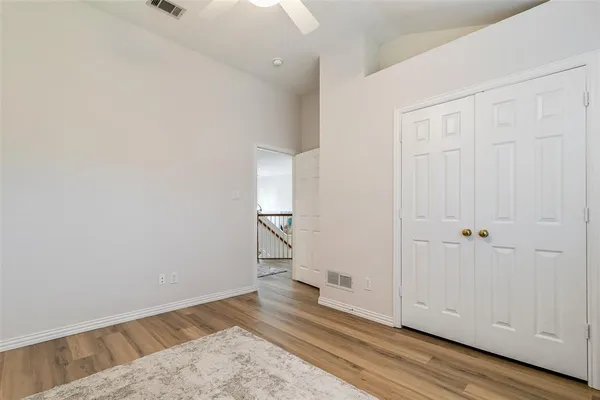 a view of a room with wooden floor and white wall