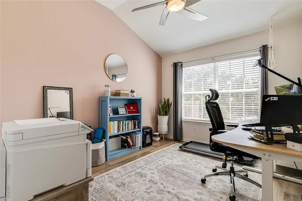 a view of a workspace with furniture and a window