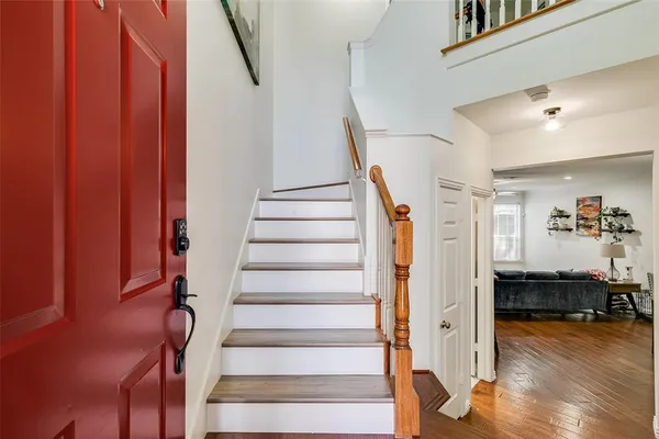 a view of entryway and hall with wooden floor