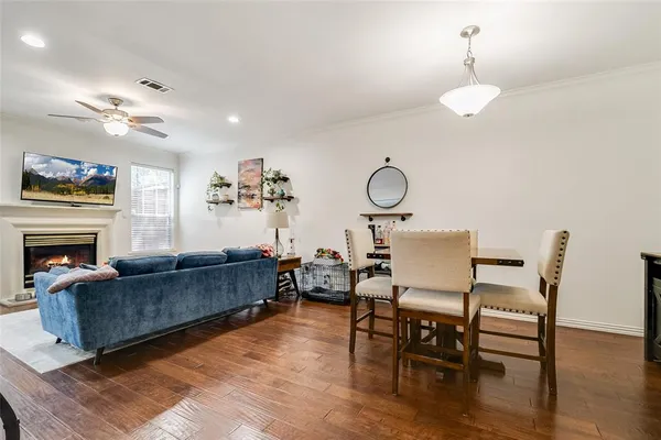 a living room with furniture a fireplace and wooden floor