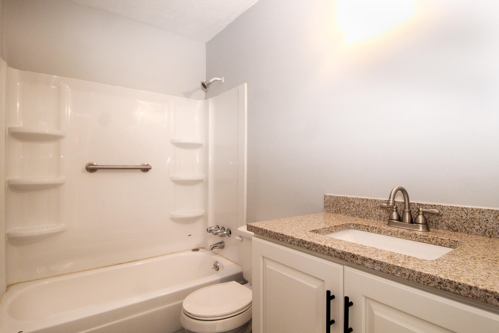 210 Pelham Road, Unit 218A Fort Walton Beach, FL 32547 - Photo 11 of 16 a bathroom with a granite countertop sink toilet and shower