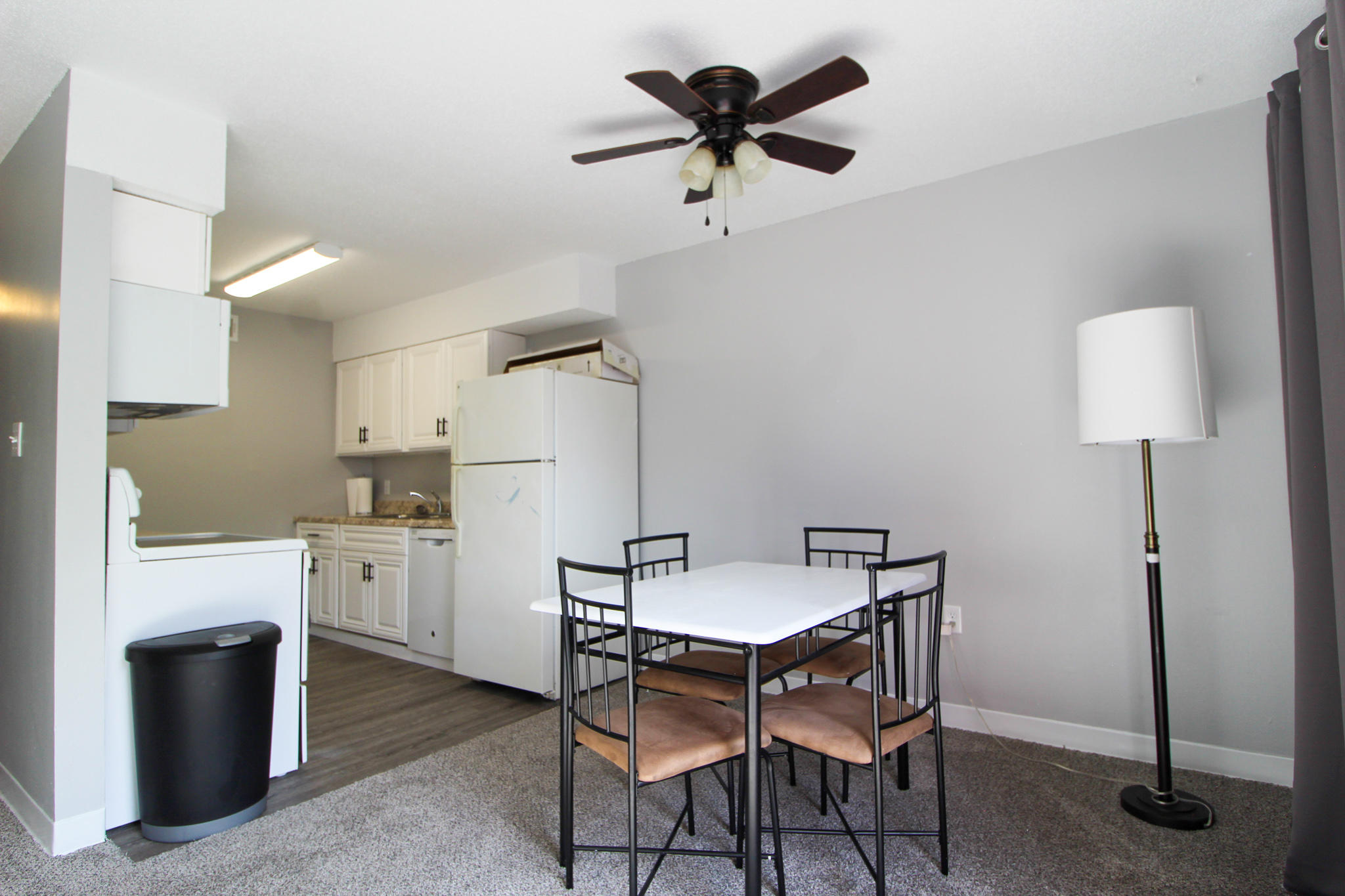 210 Pelham Road, Unit 218A Fort Walton Beach, FL 32547 - Photo 4 of 16 a view of a kitchen with a dining table and a refrigerator