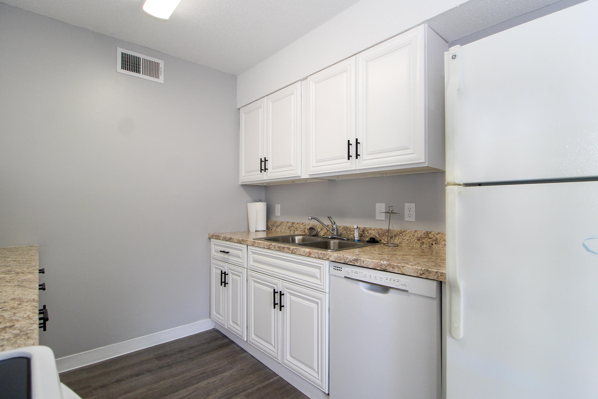 210 Pelham Road, Unit 218A Fort Walton Beach, FL 32547 - Photo 6 of 16 a kitchen with stainless steel appliances granite countertop a sink and a refrigerator