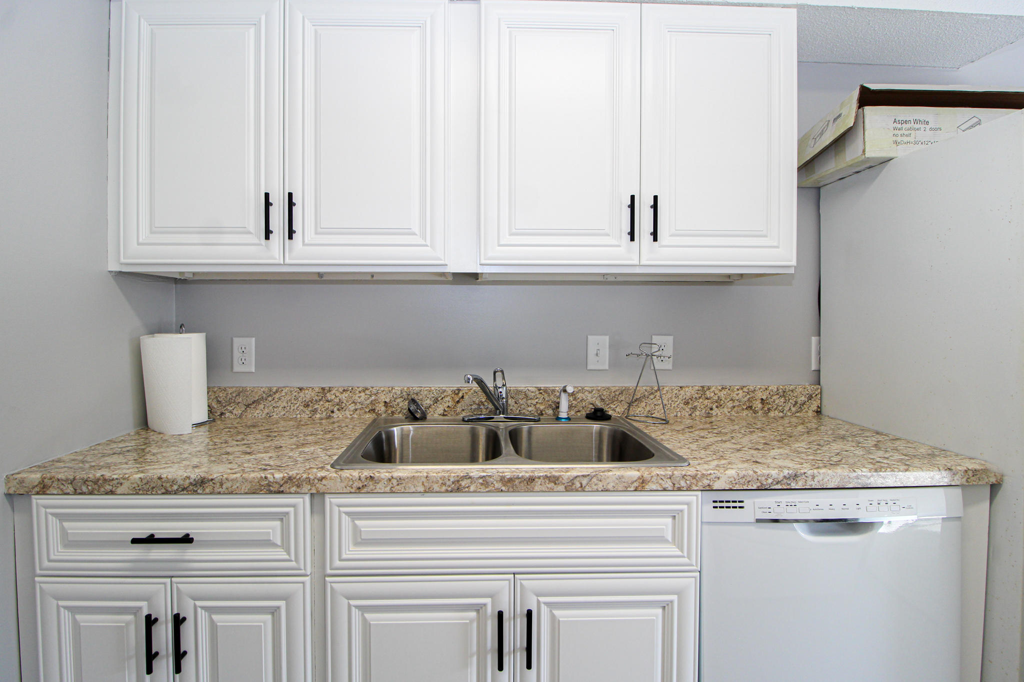210 Pelham Road, Unit 218A Fort Walton Beach, FL 32547 - Photo 7 of 16 a kitchen with granite countertop white cabinets and a sink
