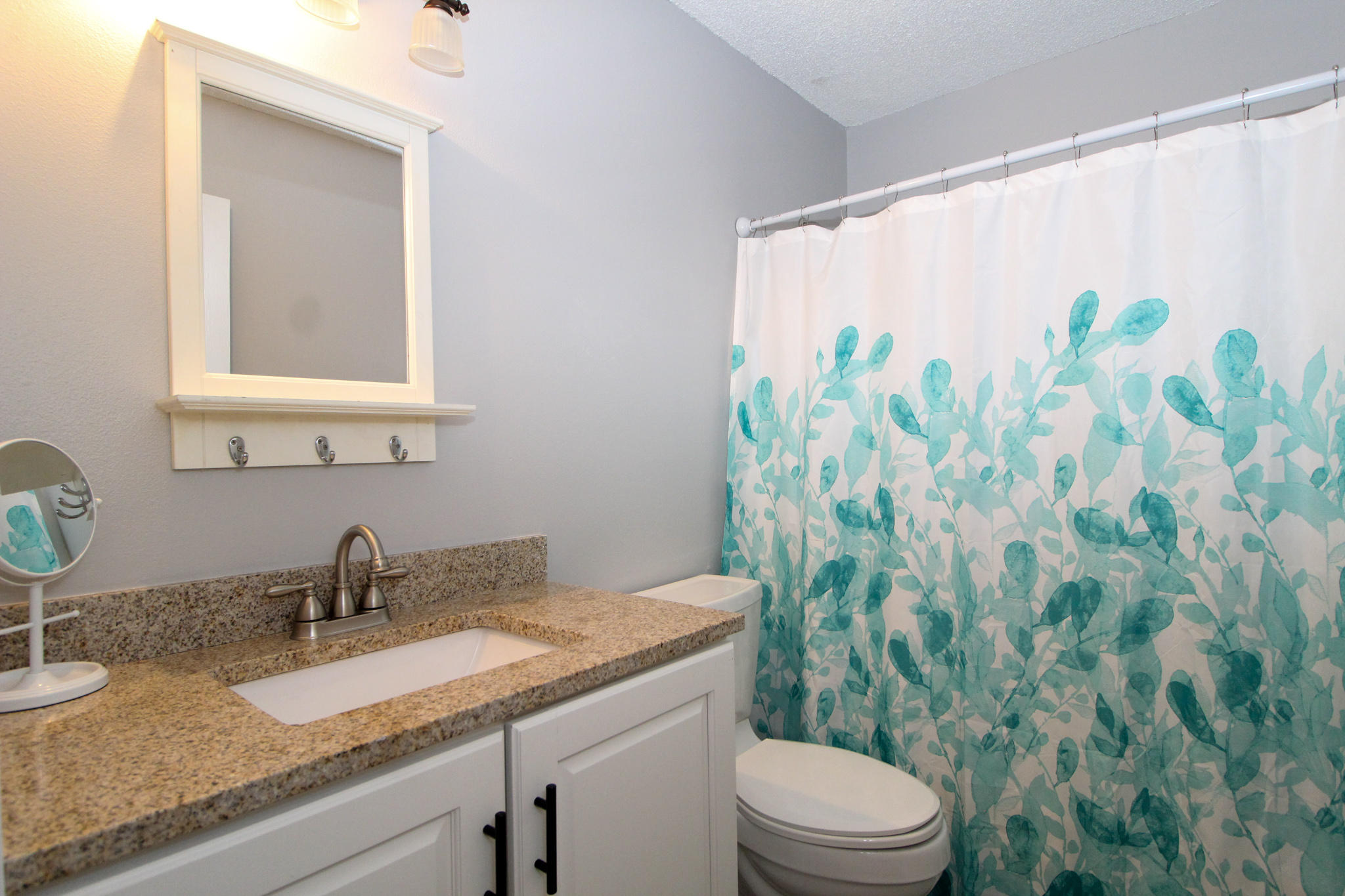 210 Pelham Road, Unit 218A Fort Walton Beach, FL 32547 - Photo 9 of 16 a bathroom with a granite countertop sink and a toilet
