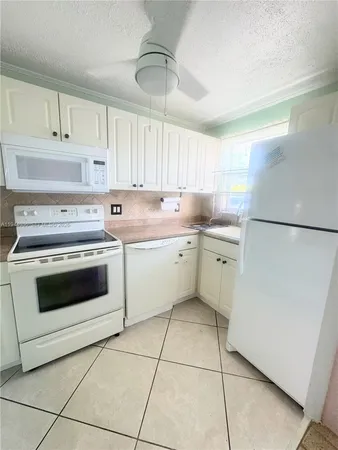 a kitchen with a stove a sink and a refrigerator