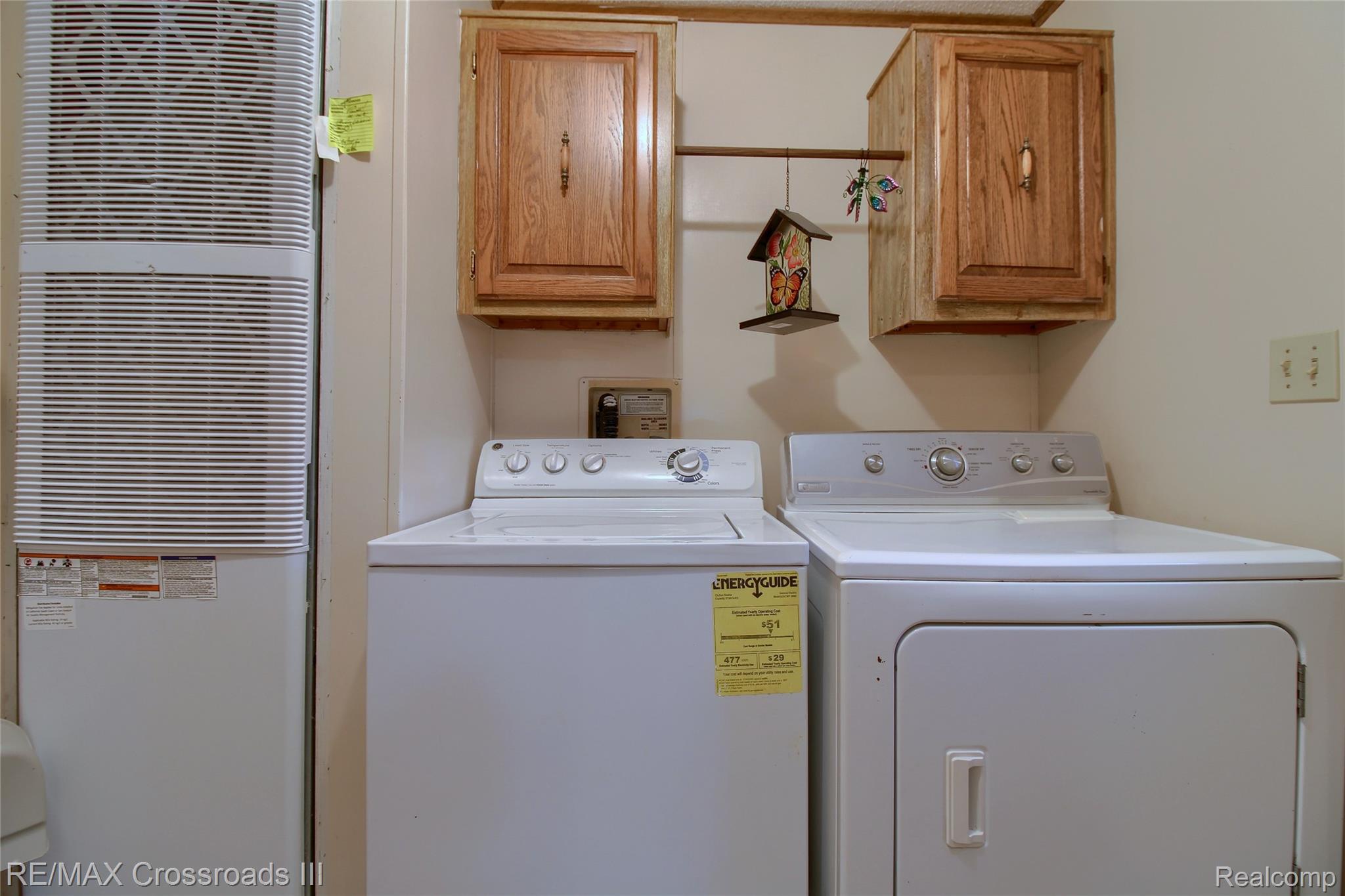 48620 Wear Road Belleville, MI 48111 - Photo 23 of 24 Laundry room with a heating unit, washing machine and dryer, and cabinet space
