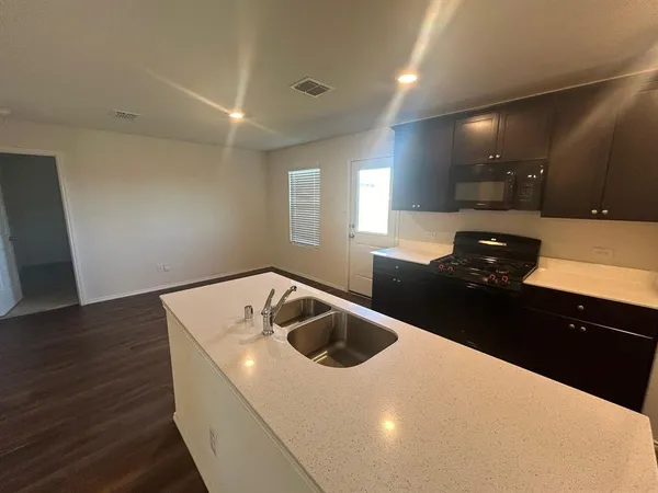 a kitchen with a sink and a refrigerator
