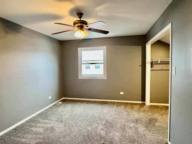 a view of room with window and ceiling fan
