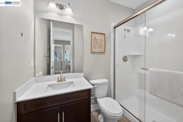 a view of a patio with table and chairs potted plants and large tree
