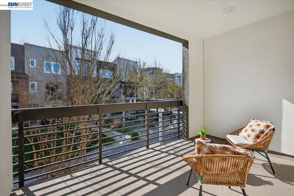 a living room with furniture a fireplace and a large window